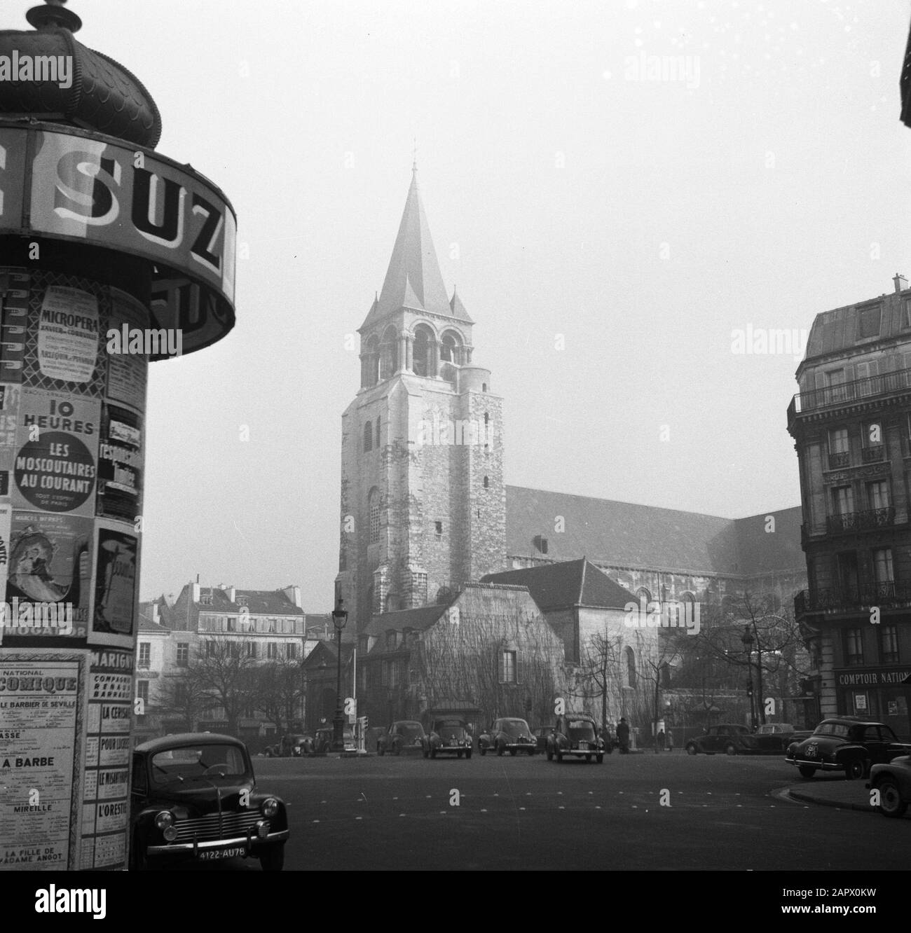 Paris. The church of St. Germain-des-Prés seen from the Rue de Rennes with an advertising column in the foreground Date: undated Location: France, Paris Keywords: architecture, cars, church buildings, church towers, billboards, Romanesque, street images Stock Photo