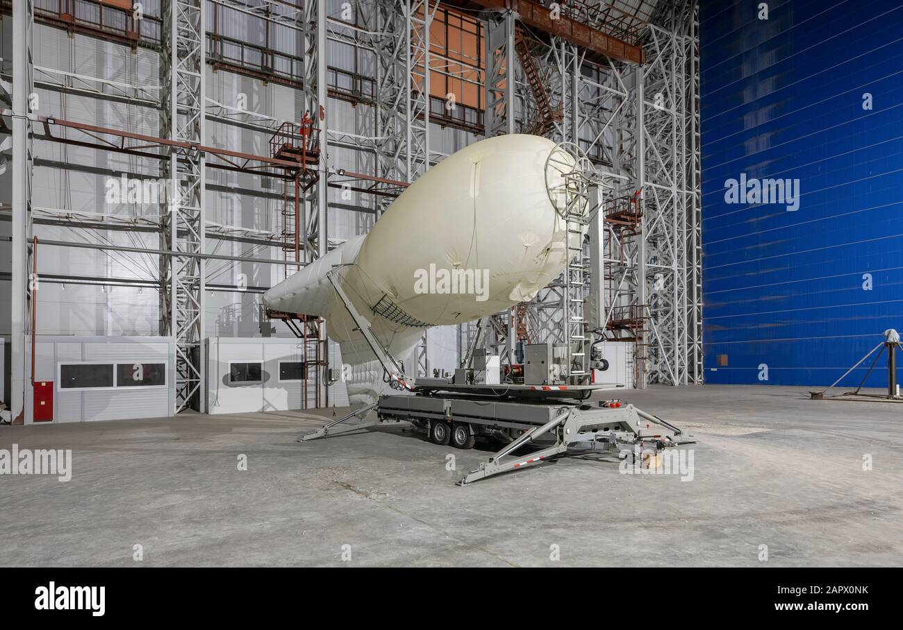 Aerostat on a mobile mooring platform insidean aircraft hangar Stock Photo