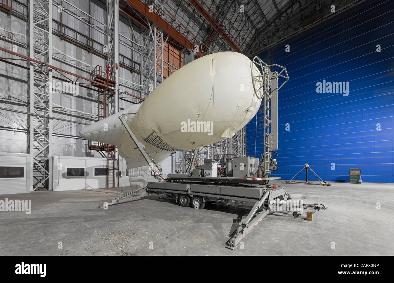 Aerostat on a mobile mooring platform inside an big airship hangar Stock Photo