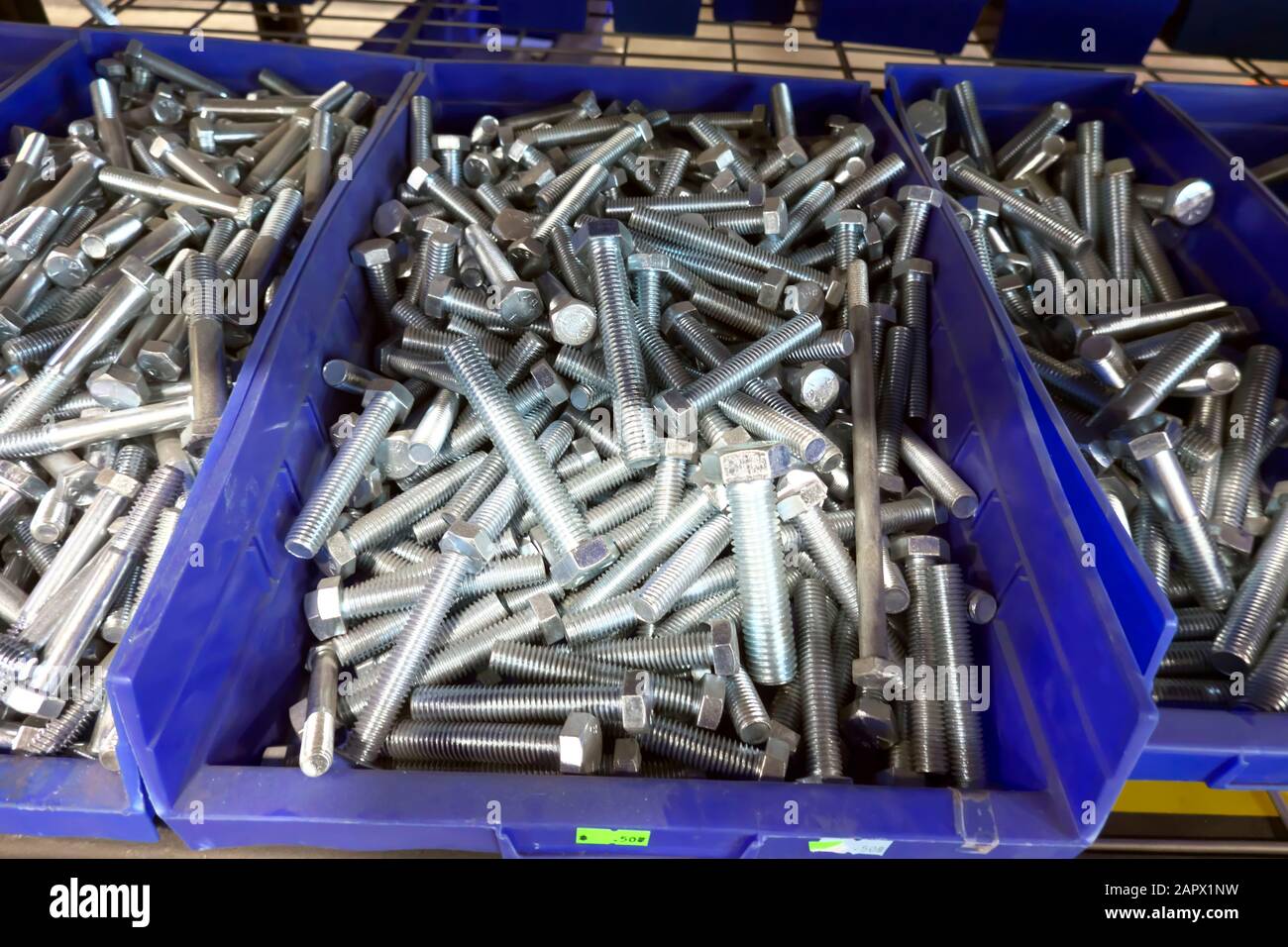 Bolts in blue bins at a hardware store Stock Photo Alamy
