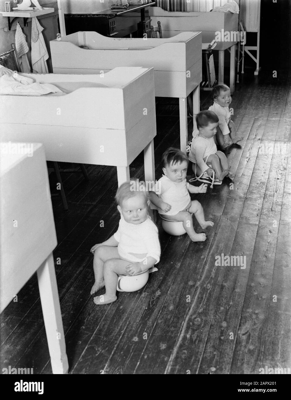 Tehuis Toddlers in the home sit together at the po Annotation