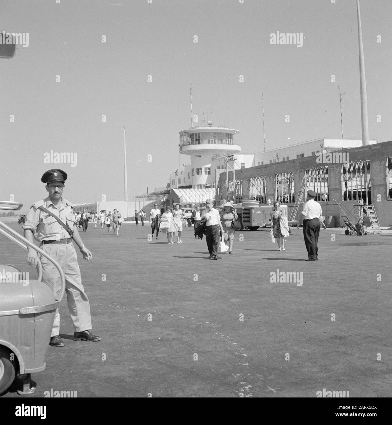Israel: Lydda Airport (Lod)  Travelers at the airport with the control tower in the background Date: undated Location: Israel, Lod Airport, Lydda Airport Keywords: arrival and departure, aviation, travelers, control towers Stock Photo