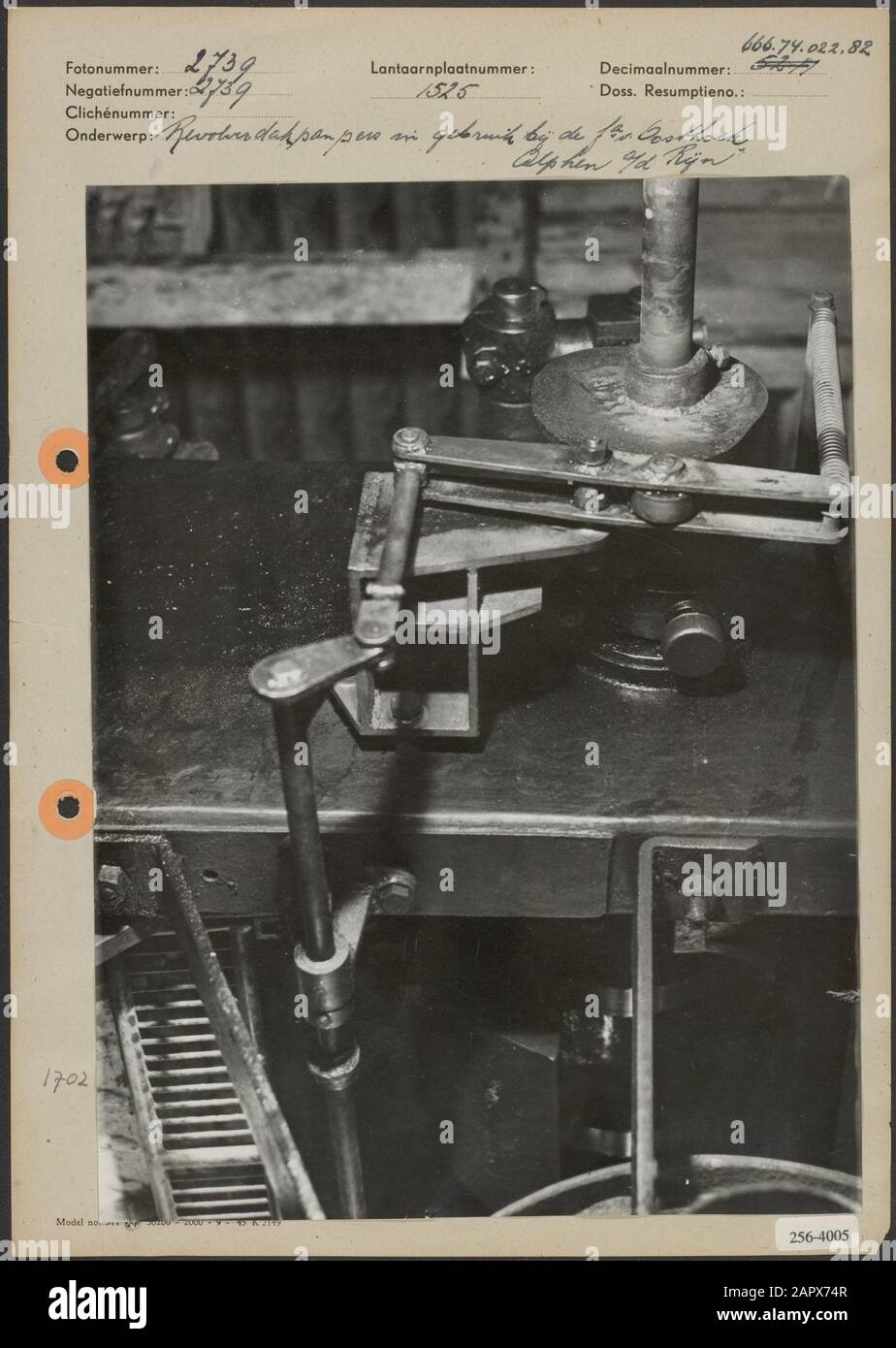Roof tile press  Revolver roof tile press in use by the company Oosthoek in Alphen aan den Rijn Date: undated Location: Alphen aan den Rijn, South-Holland Keywords: tiles, machinery Institution name: Fa. Oosthoek Stock Photo