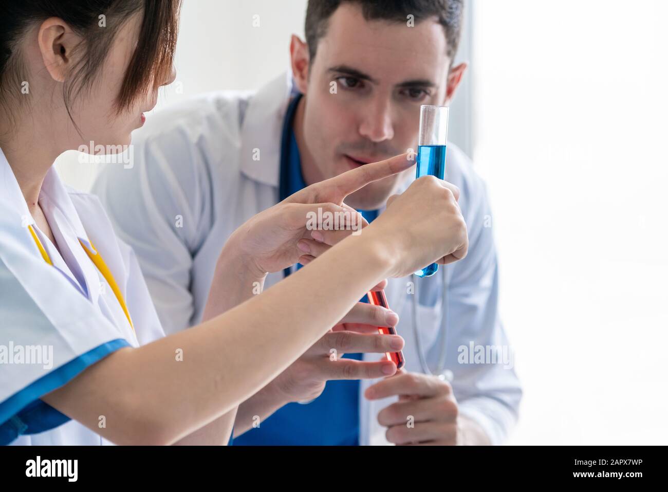 Group of scientists wearing lab coat working in laboratory while