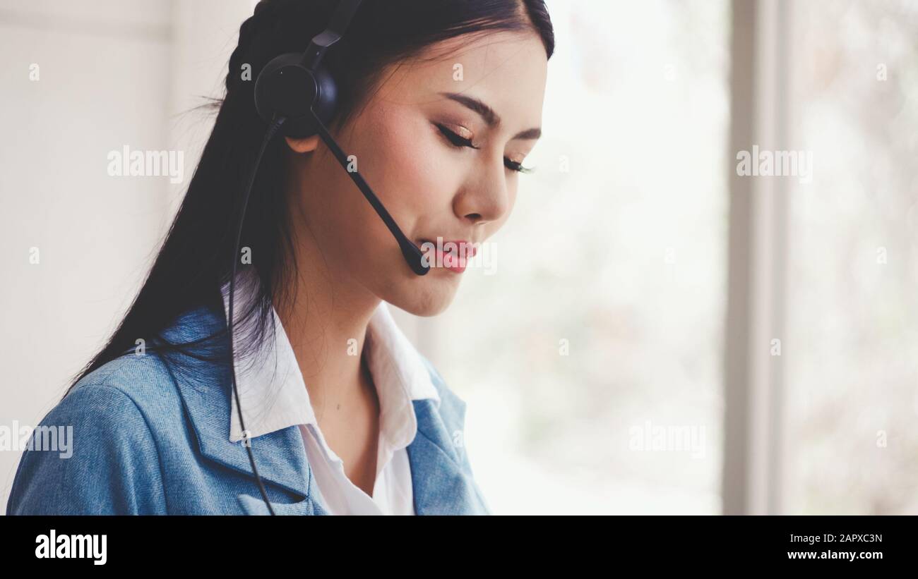 Customer support agent or call center with headset works on desktop