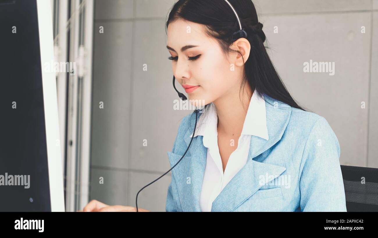 Customer support agent or call center with headset works on desktop