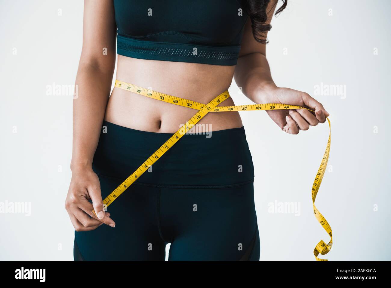 Close Up Shot Of Woman With Slim Body Measuring Her Waistline
