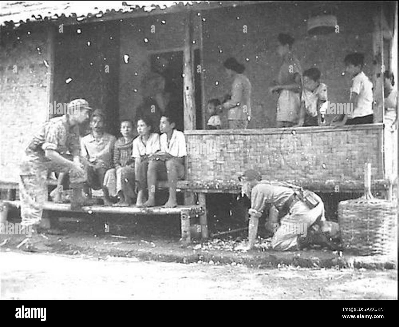 Action regiment 3 Princess Irene Brigade/Colonel Servais [Belgian Military Mission] a/d Wine Purchase Bay  Souk Sector: while patrol scrupulously searches the houses, makes the chaplain a chat with the population. He is in conversation with a former student of the Bandoengse Technische Hogeschool, who is currently working as tani. Date: 29 October 1947 Location: Indonesia, Indonesia, Dutch East Indies, Soekaboemi Keywords: chaplains, searches, conversations, patrols, students Stock Photo