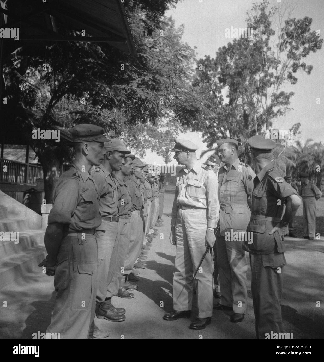 General Rail in Palembang:Posts in West Sumatra  Rail inspects a division of battalion Gajah Merah. Behind him Colonel Mollinger Annotation: Is there a mistake in series? Date: 1947/01/01 Location: Indonesia, Dutch East Indies Stock Photo