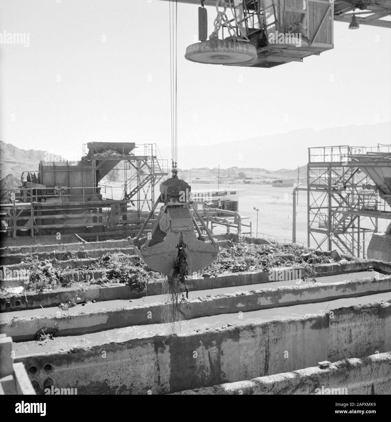 Israel - Timna  Timna in the Negev Desert; the site of copper mines with concrete boxes for storage of materials and a dragline Date: January 1, 1963 Location: Israel, Negev, Timna Keywords: excavators, industry, copper, mining, warehouses, deserts Stock Photo