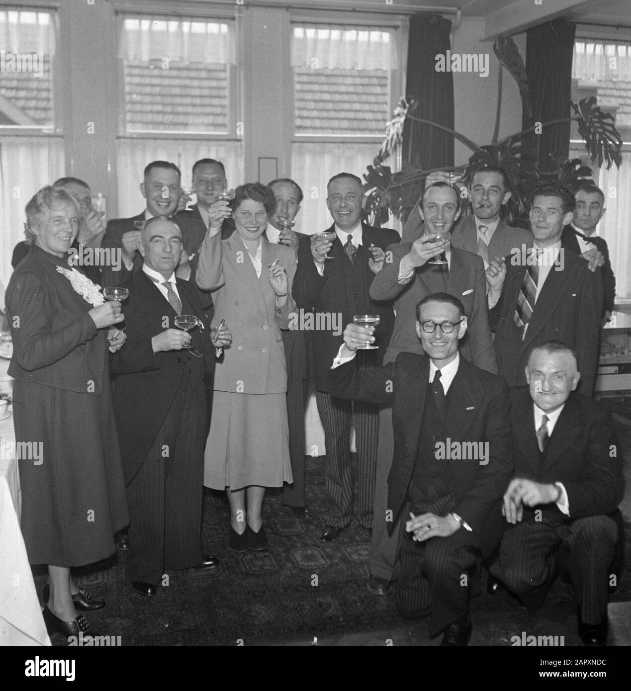 tobacco eindhoven 50th anniversary cigar factory Karel I Eindhoven Toasting group of people  at reception, some of them smoking Date: 1 January 1950 Location: Eindhoven  Keywords: drinks, factories, receptions, tobacco industry Stock Photo