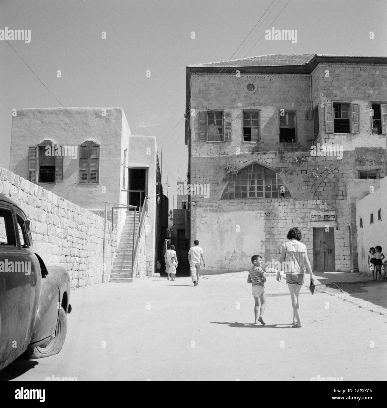 Israel 1964-1965: Akko (Acre), Citadel-prison  Pedestrians walk towards an alley across the site of the Citadel-prison Annotation: A citadel is a (often star-shaped) reinforcement that dominates a fortified city and makes it defensible independently. When the British conquered Akko, they made various changes to the building. They turned the whole building into the central prison of Palestine. After the establishment of the State of Israel became the prison a psychiatric hospital Date: 1964 Location: Acre, Israel Keywords: prisons, psychiatric hospitals, alleys, pedestrians Stock Photo