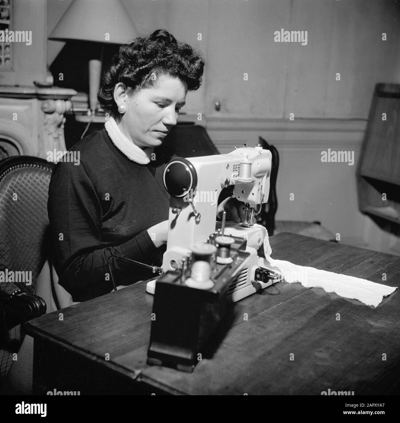 Residents of an apartment building in Paris Woman at work behind the