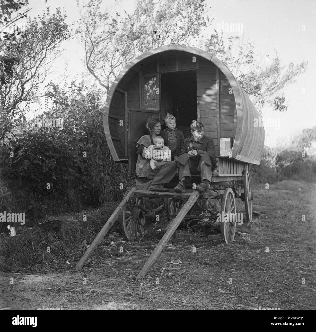 Tinkers in Ireland Woman with children on the goat of a covered wagon