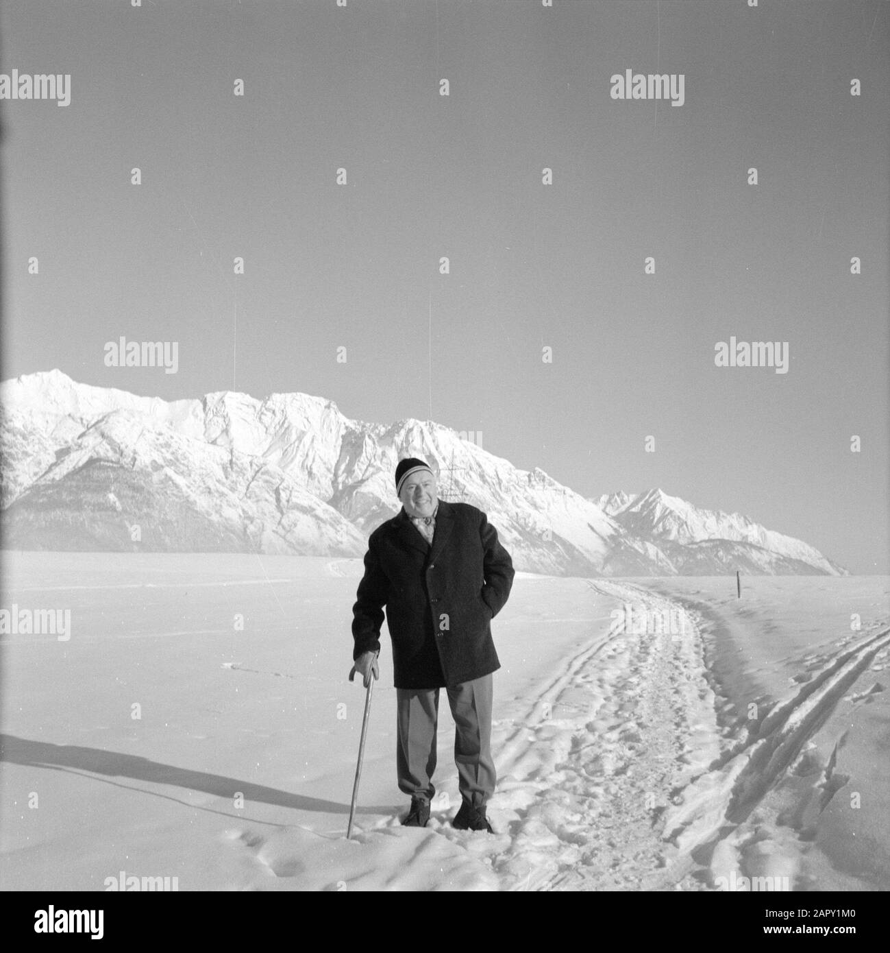 Winter in Tyrol  Willem van de Poll poses in the snow with in the background the Karwendel Mountains Date: January 1960 Location: Austria, Sistrans, Tyrol Keywords: mountains, landscapes, snow, holiday, hiking, winter Personal name: Poll, William of the Stock Photo