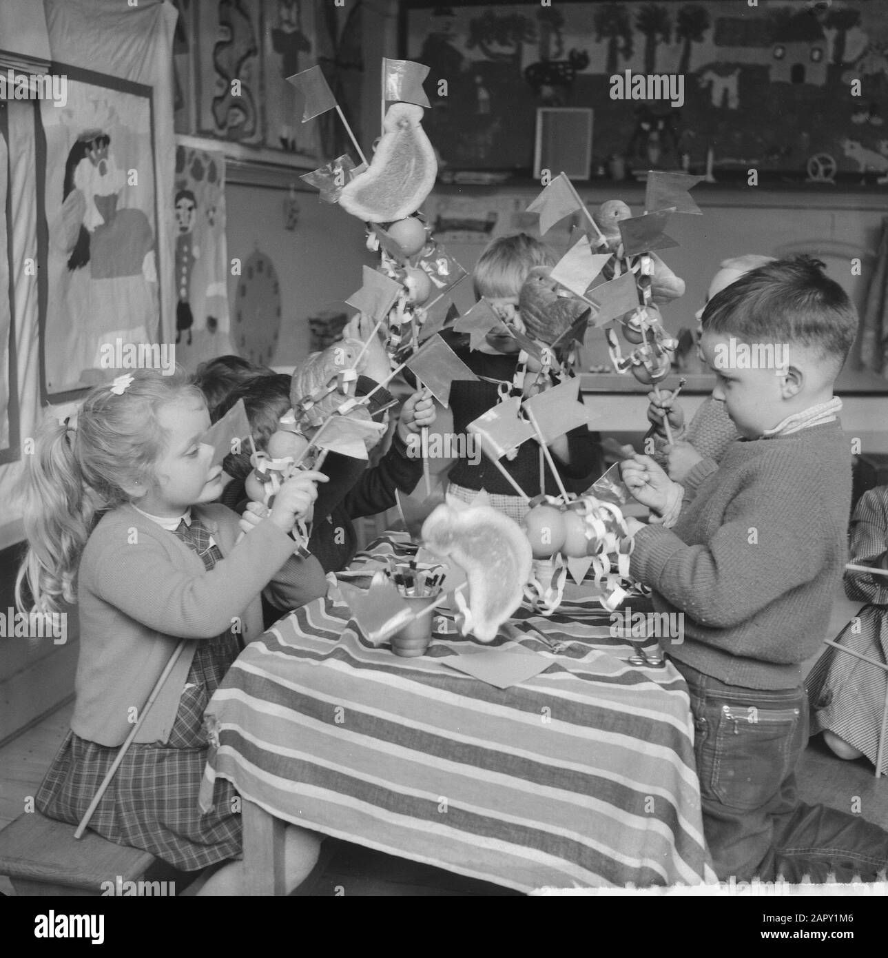 Preparation by children for Palmpases. Children busy formatting the Palmpases Date: March 24, 1961 Keywords: Children.And Stock Photo