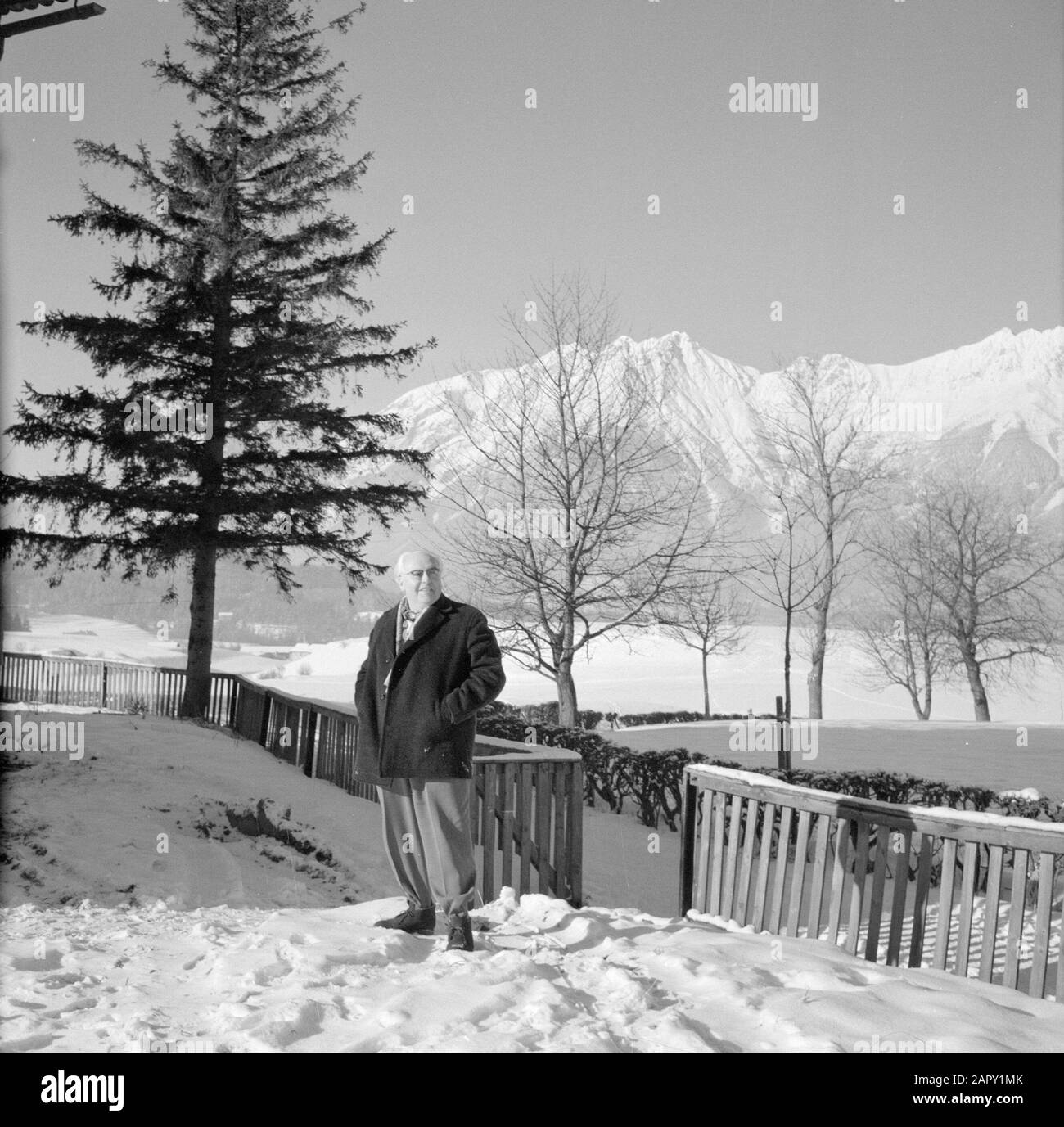 Winter in Tyrol  Willem van de Poll poses in the snow with in the background the Karwendel Mountains Date: January 1960 Location: Austria, Sistrans, Tyrol Keywords: mountains, landscapes, snow, holiday, winter Personal name: Poll, William van de Stock Photo