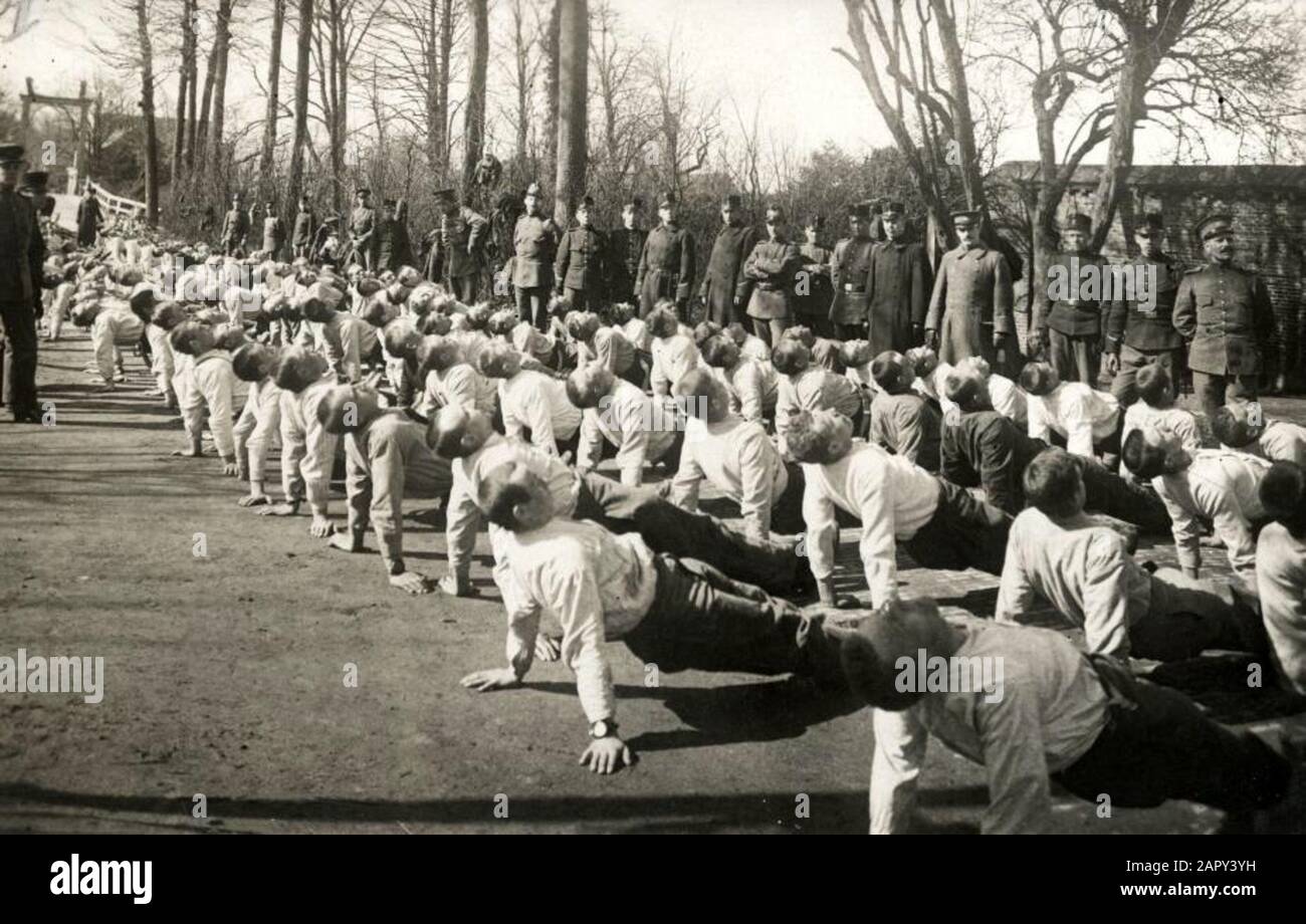 World War I, Dutch army. Gymnastic exercises Dutch soldiers in the open air, as gym rooms are used for accommodation. Photo: class recruits after one and a half months of exercise; gymnastic exercise lying support back. Netherlands, 1915. Stock Photo