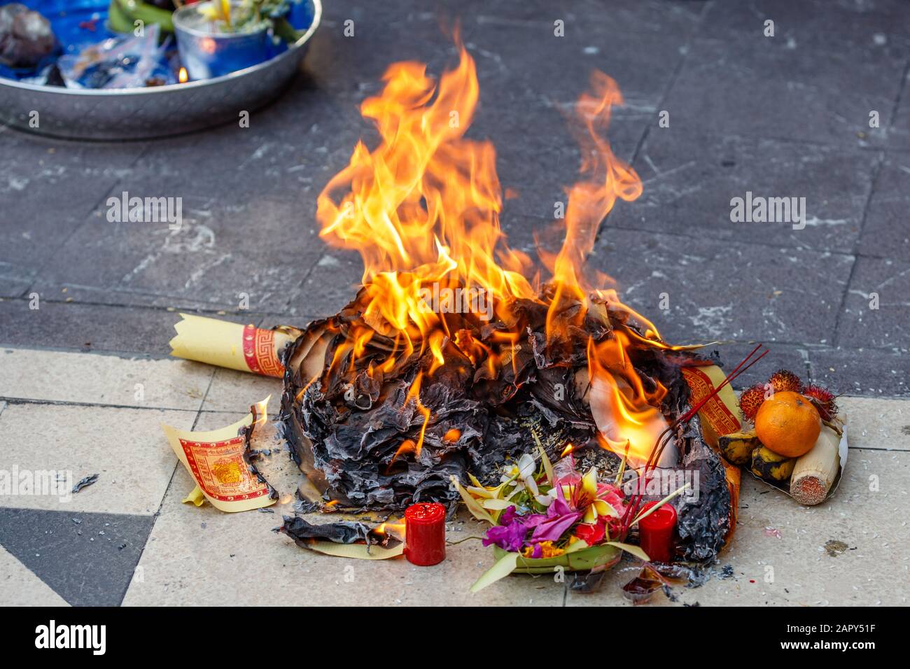 Burning offerings for Lunar New Year (Imlek) celebration ceremony at Chinese Buddhist temple Vihara Dharmayana Kuta, Bali, Indonesia. Stock Photo