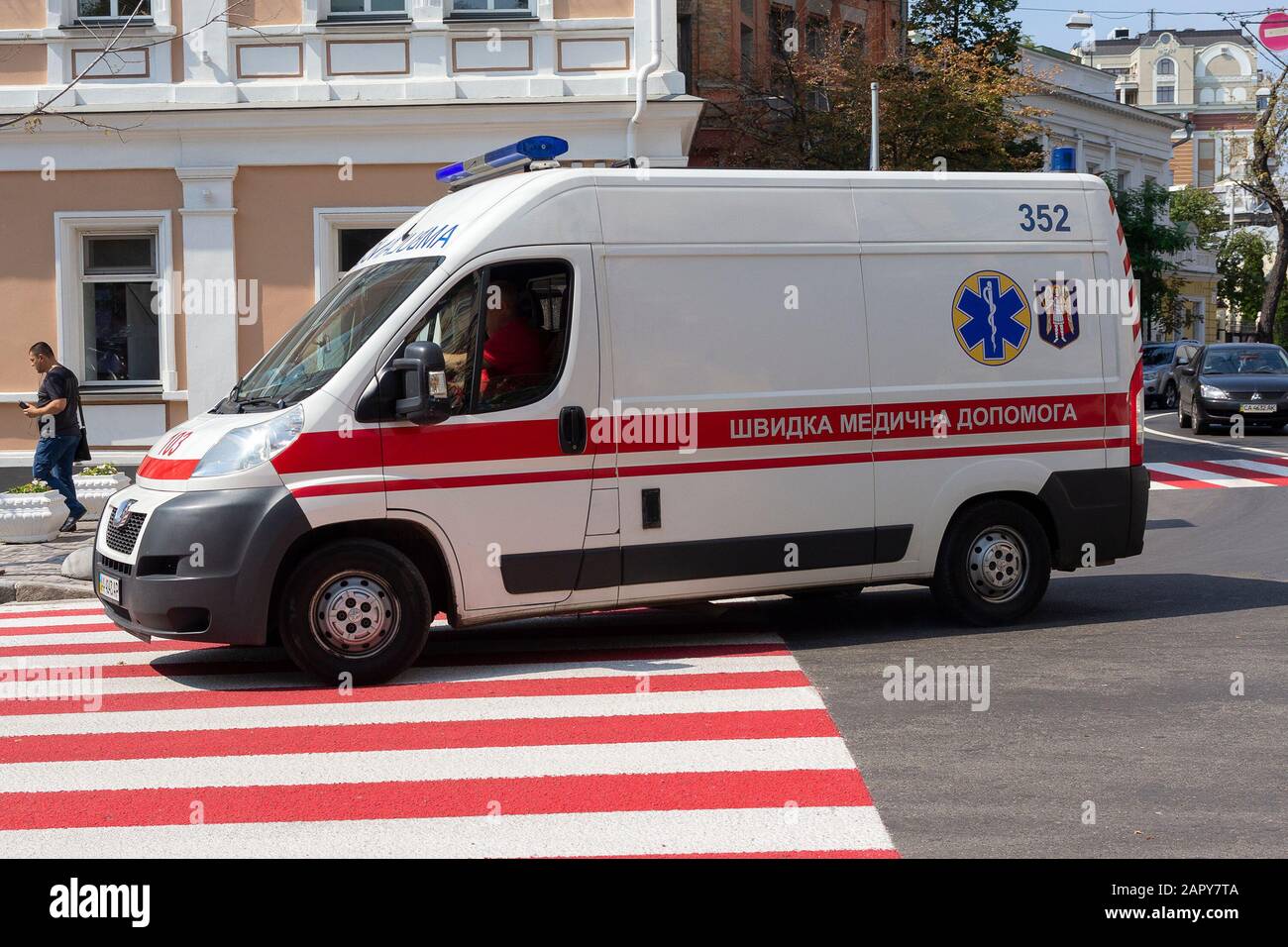 Kiev, Ukraine - August 21, 2018: White ambulance quickly drives along a wide city street Stock Photo