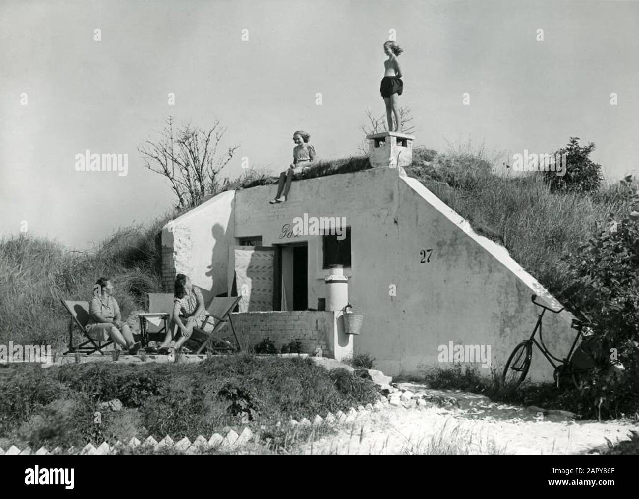 Cottages. The bunker-holiday village in Zandvoort, Netherlands, August 11, 1947. Photo: Mothers look at girls, who are on the bunker. Stock Photo
