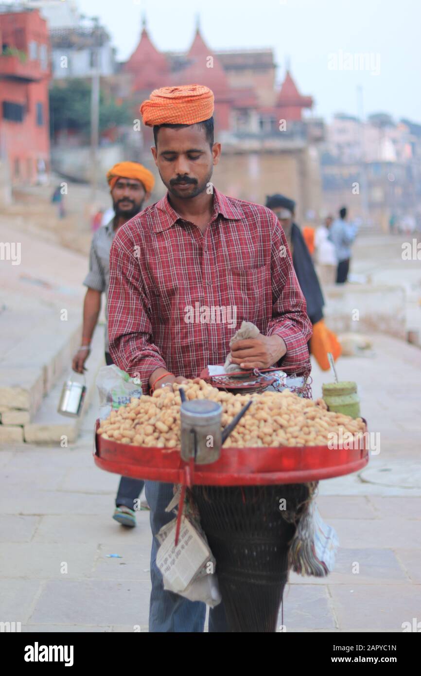 A peanut seller with orange turban in Varanasi Stock Photo