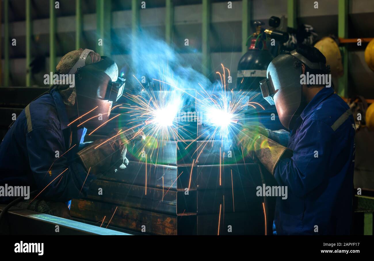 Worker welding the steel part Stock Photo