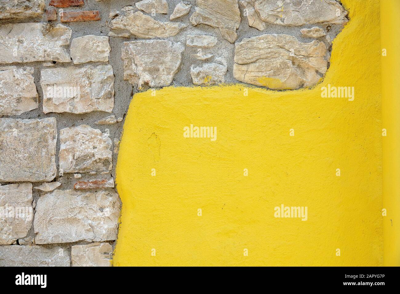 Paint Yellow Rocks Closeup shot of a wall consisting of yellow paint and rocks Stock Photo ...