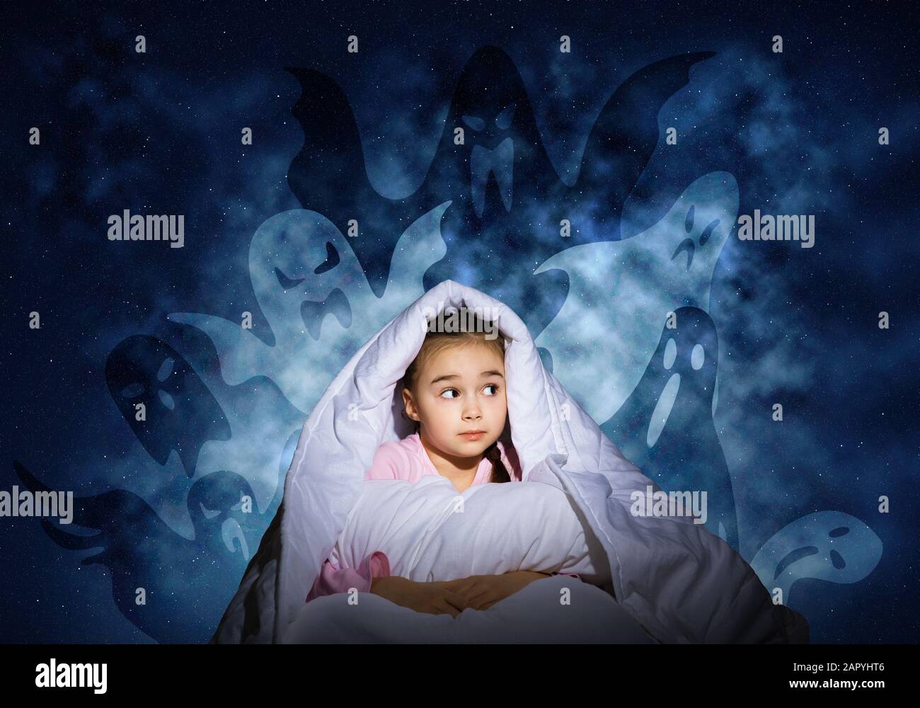 Scared girl with pillow hiding under blanket Stock Photo Alamy