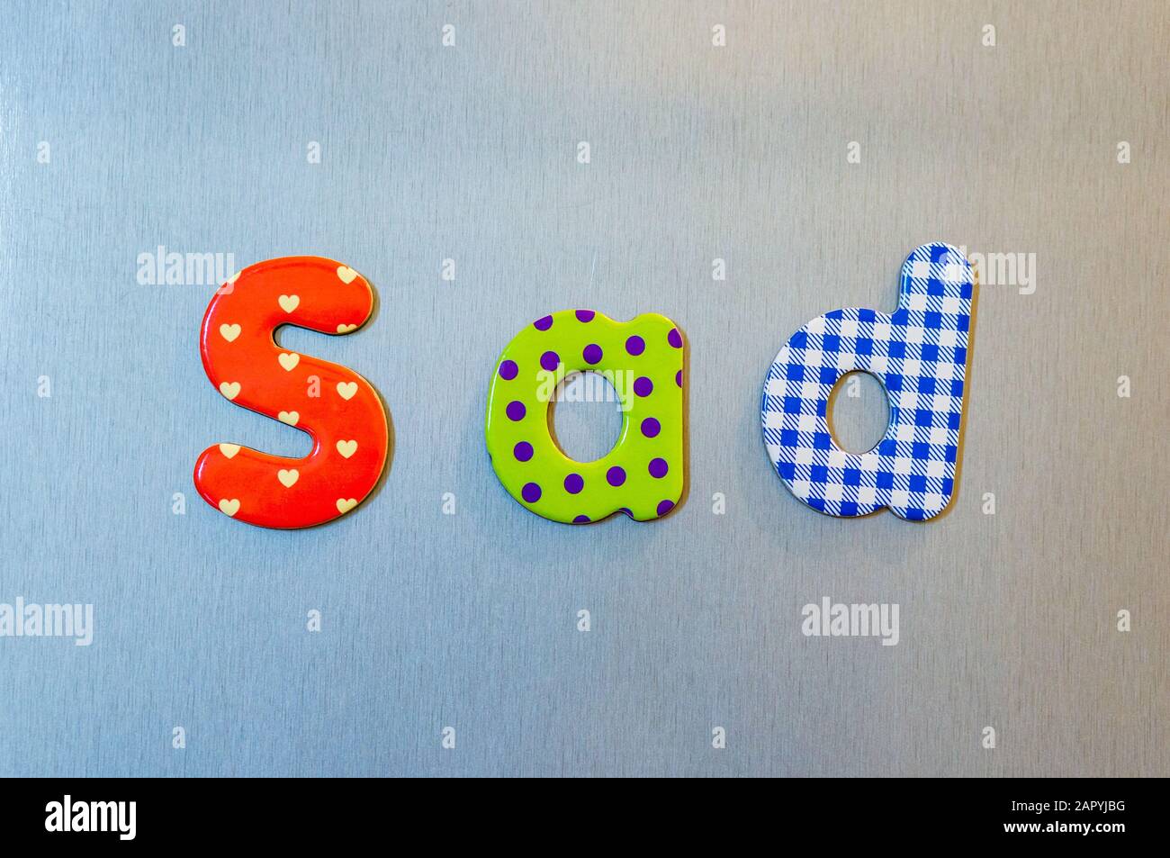 Closeup shot of colorful words spelling sad Stock Photo - Alamy