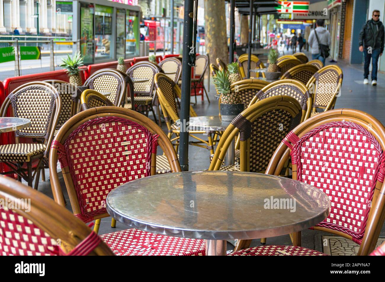 Melbourne, Australia - April 17, 2017: Outdoor cafe setting with bright chairs and pineapples on tables in Melbourne CBD Stock Photo