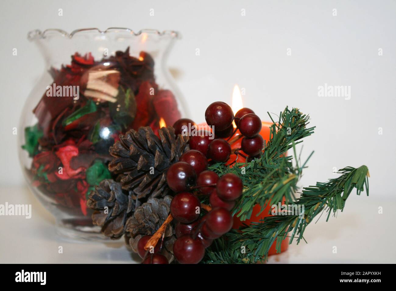 Still life with a potpourri, a candle and a branch of a Christmas tree Stock Photo Alamy