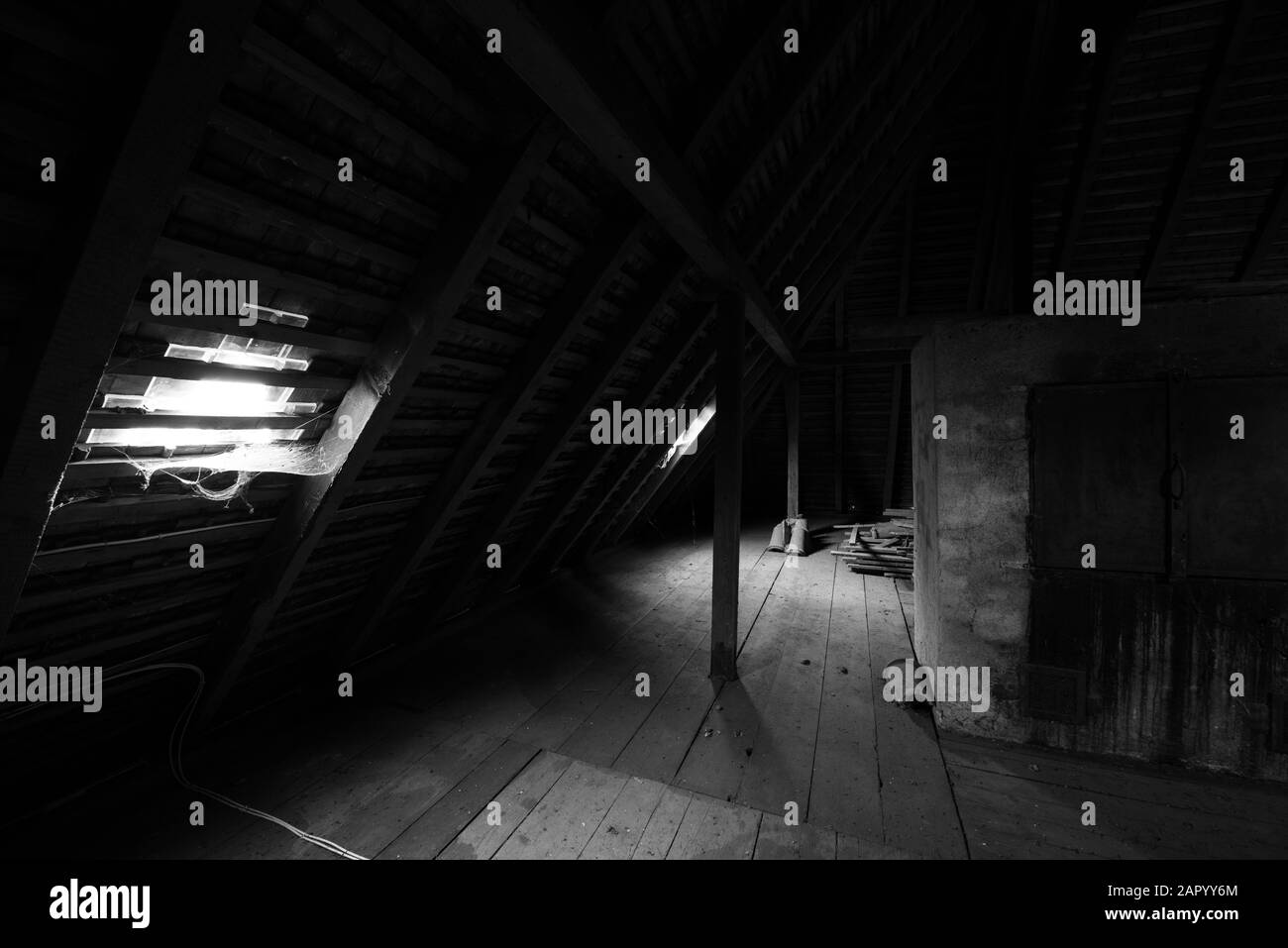 Inside the attic of an old house with cobwebs. black and white. Stock Photo