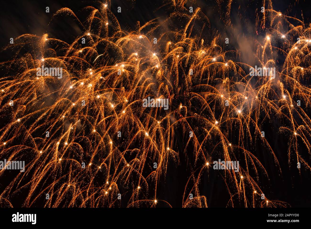Beautiful orange fireworks display in the urban for celebration on dark