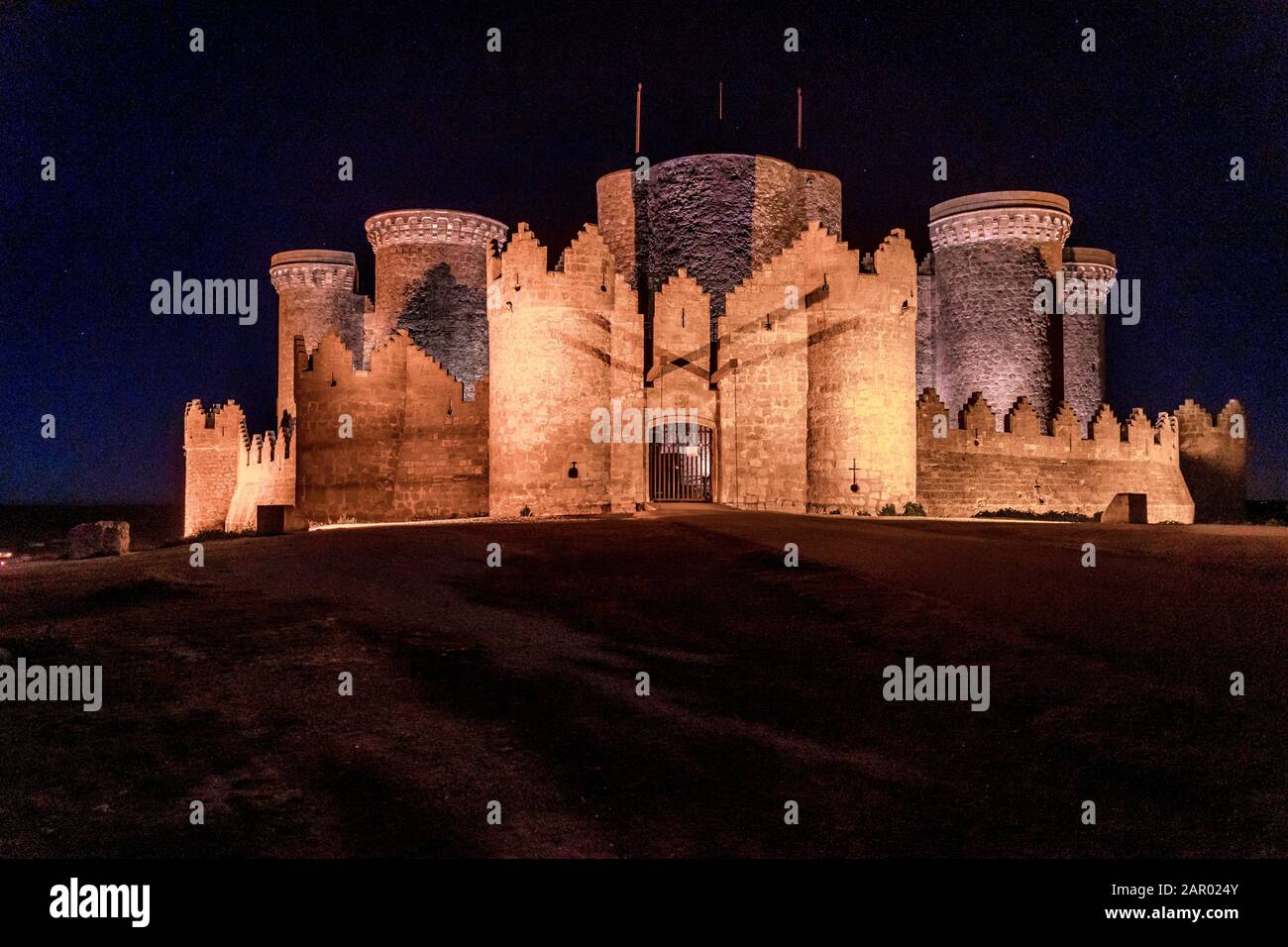 Night view of Belmonte castle in Cuenca province Spain with long stretching city walls topped with battlements Stock Photo