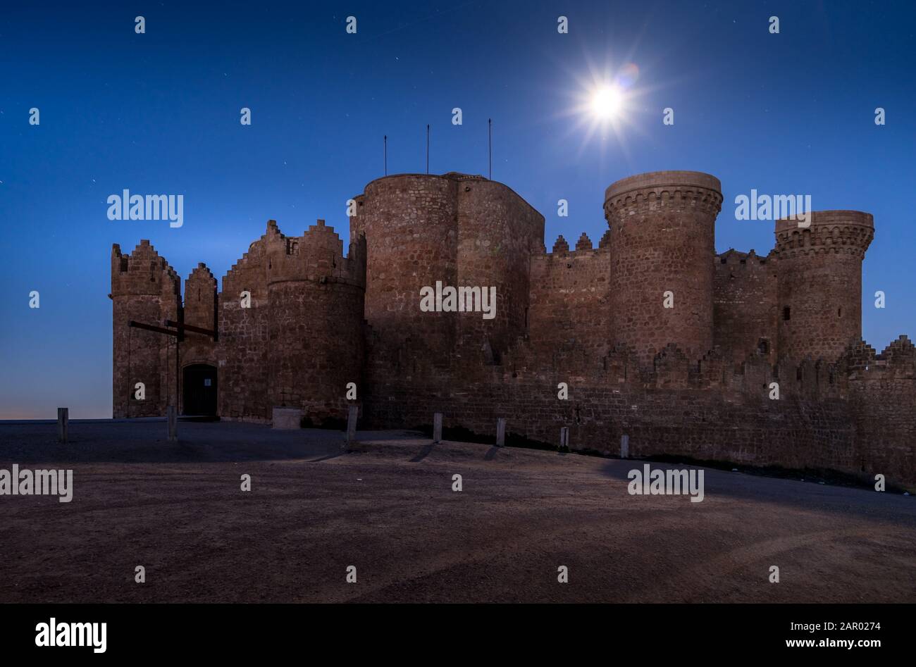Night view of Belmonte castle in Cuenca province Spain with long stretching city walls topped with battlements Stock Photo