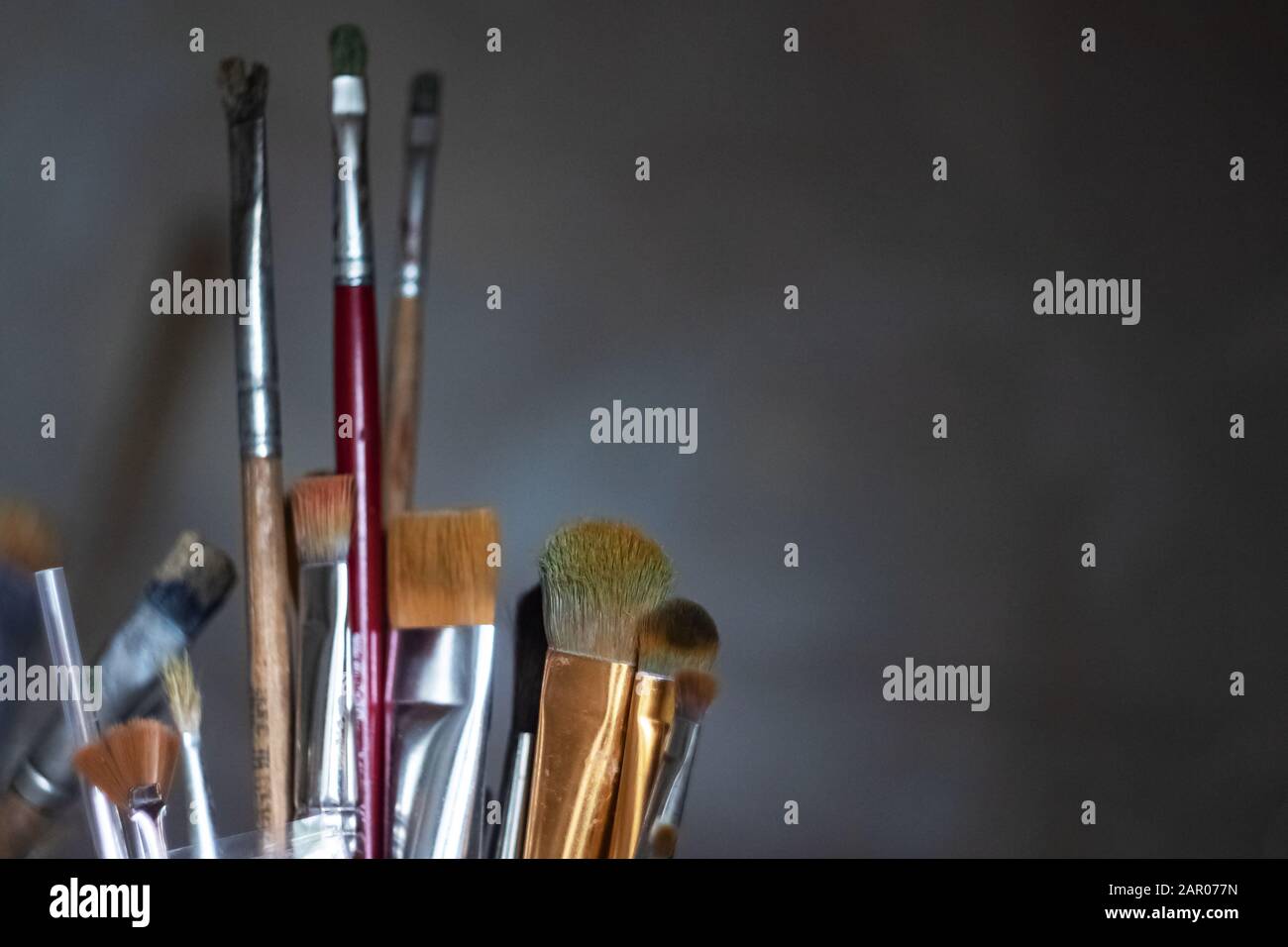 Various brushes for painting in a glass Stock Photo Alamy