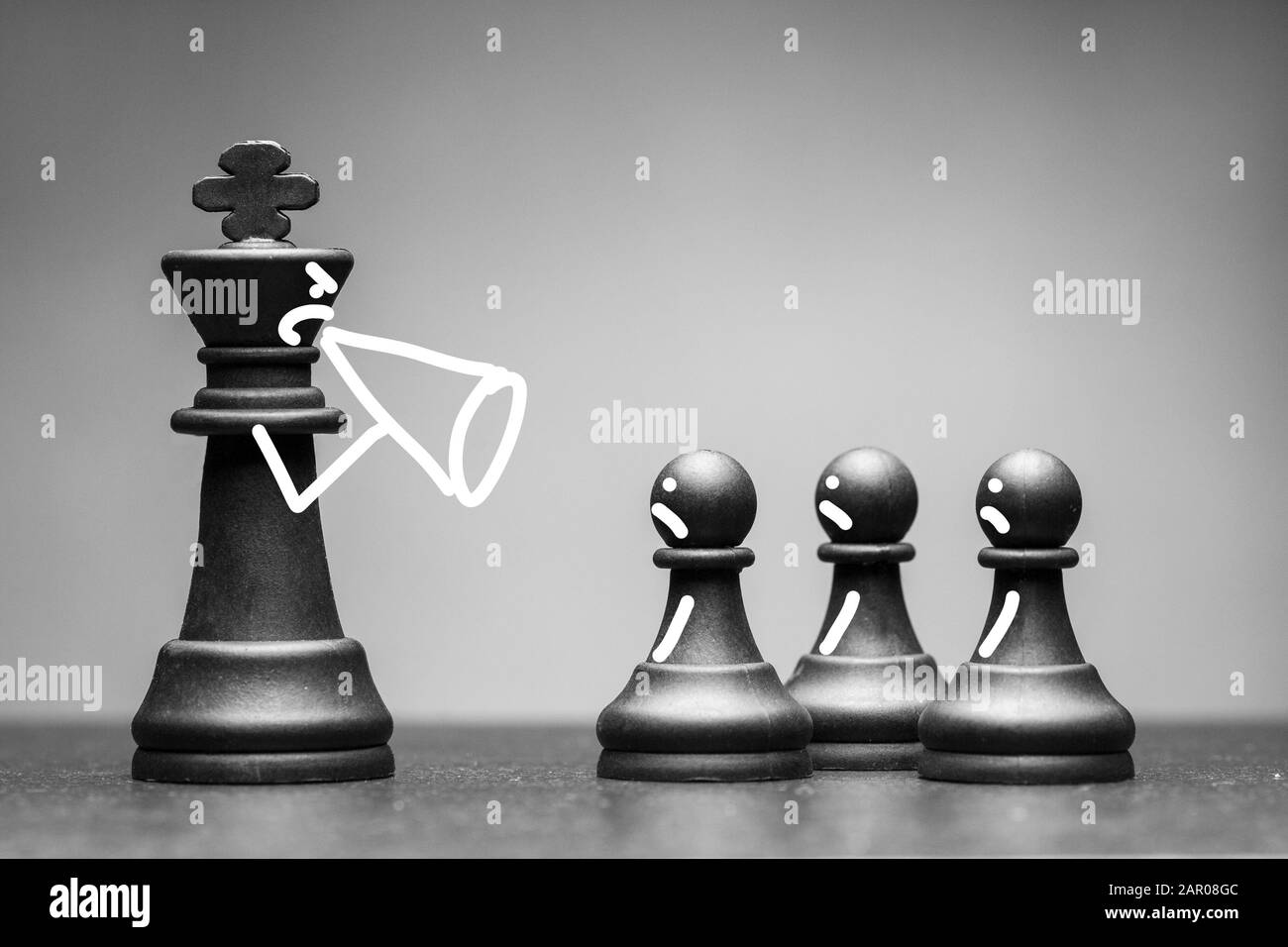 Black King chess piece yelling at his pawns Stock Photo