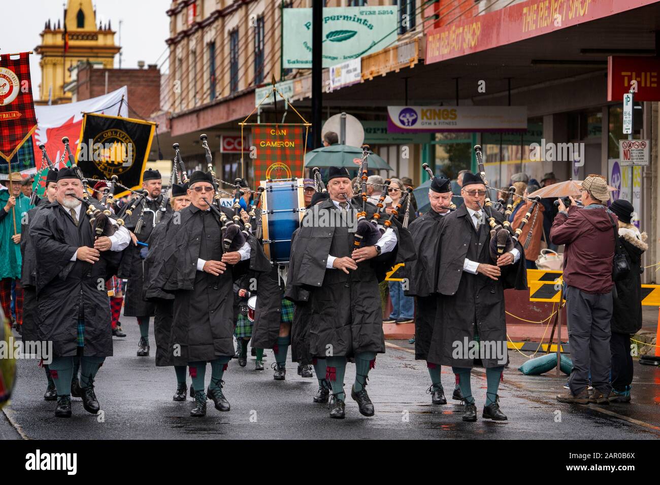 Scottish Pipe band in rain wear during opening parade of the Glen Innes Celtic Festival NSW Stock Photo