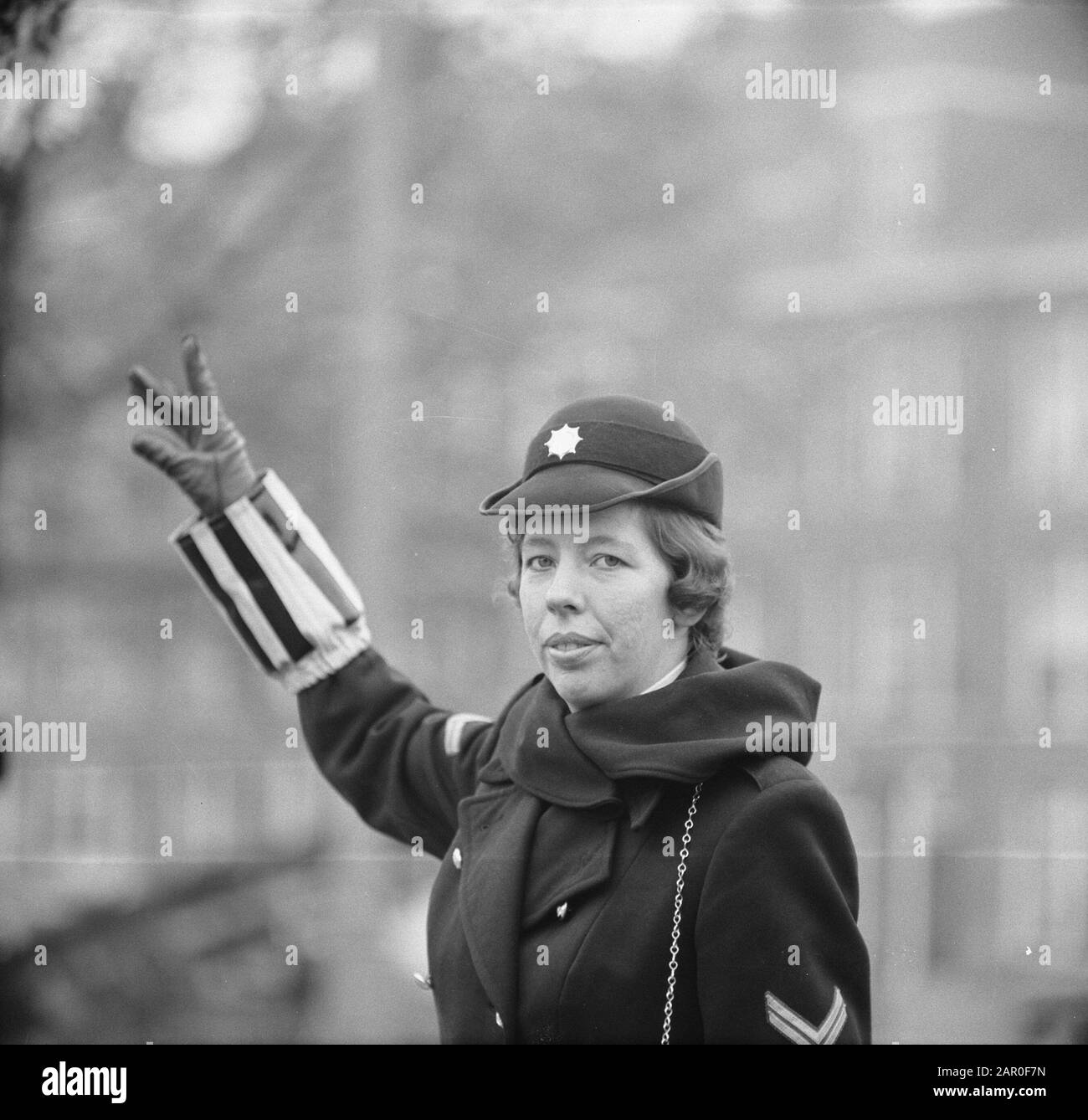 Female policemen arrange traffic in Amsterdam  Female policewoman regulates traffic Date: 28 October 1963 Location: Amsterdam, Noord-Holland Keywords: police officers Stock Photo