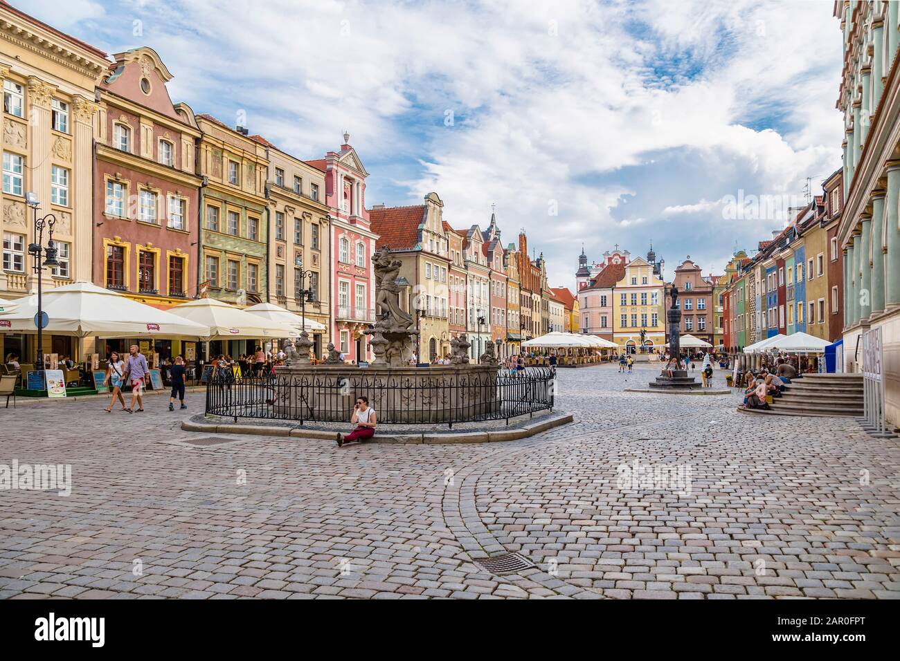 POZNAN, POLAND - AUGUST 04, 2014: An old shopping area with historical perimeter houses, a plague column and a fountain in the city of Poznan. Poland Stock Photo