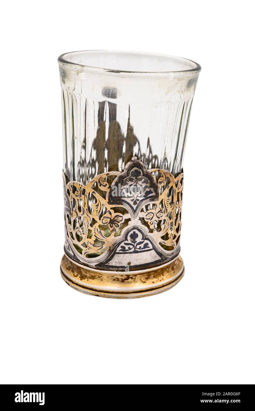 Faceted glass in an old vintage white metal Cup holder. Close up. Isolate on a white background Stock Photo