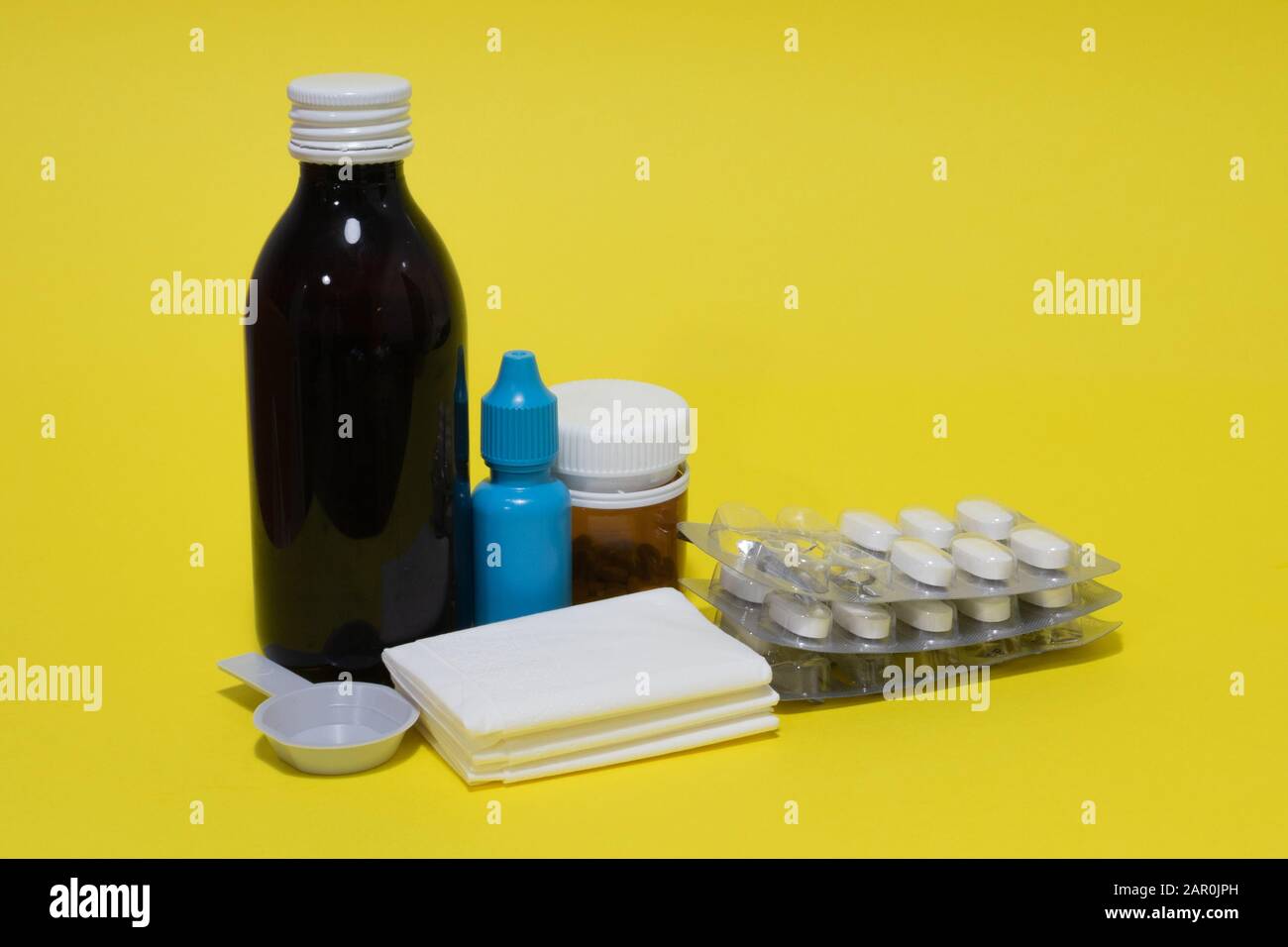 Tissues, nose drops, thermometer, cough syrup, spray, pills and blister