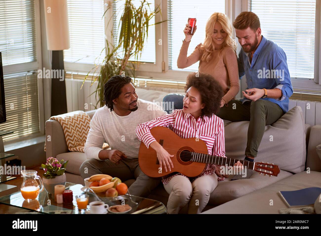 Man playing guitar inside room hi-res stock photography and images - Alamy