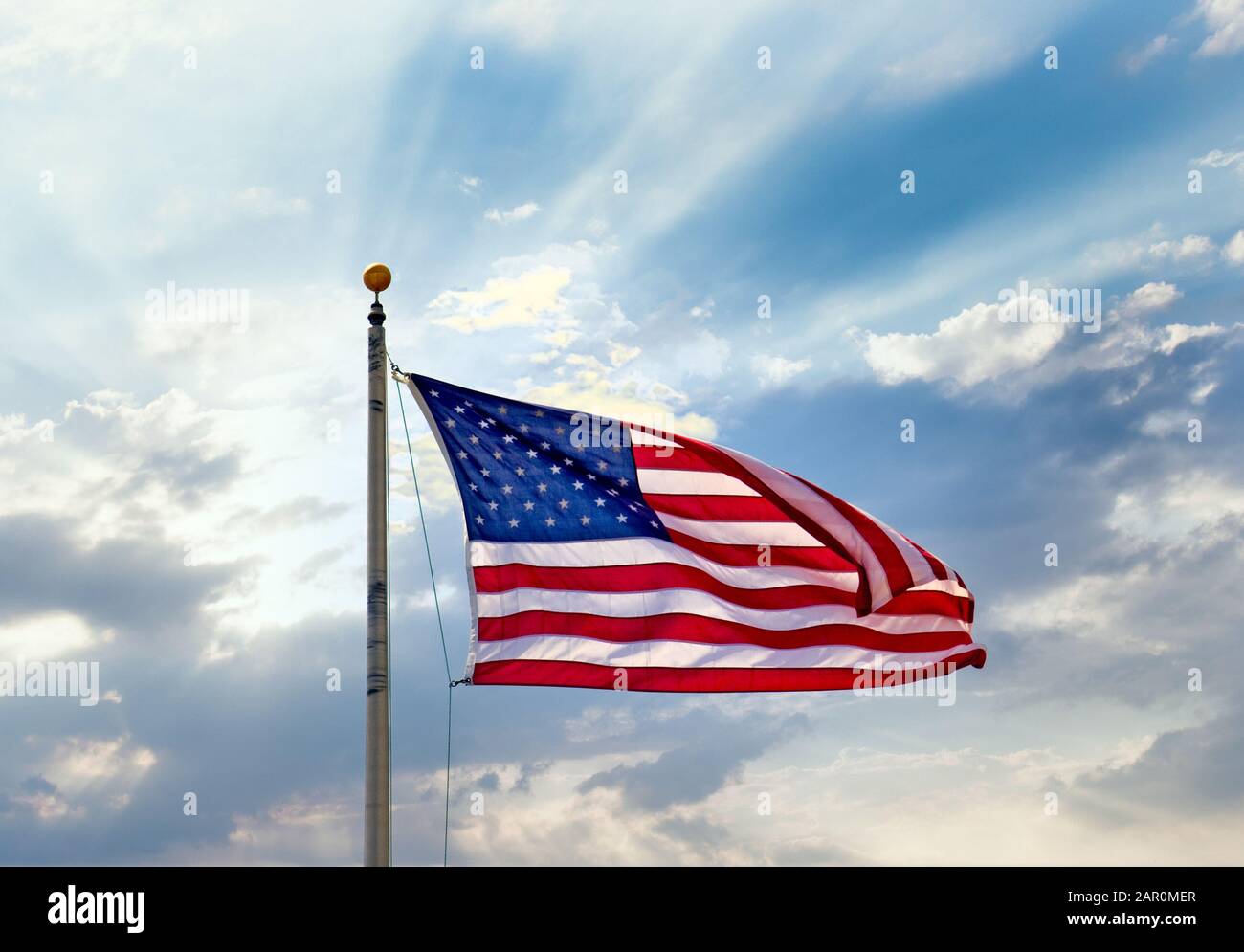 American flag on a flagpole against a blue sky hi-res stock photography ...