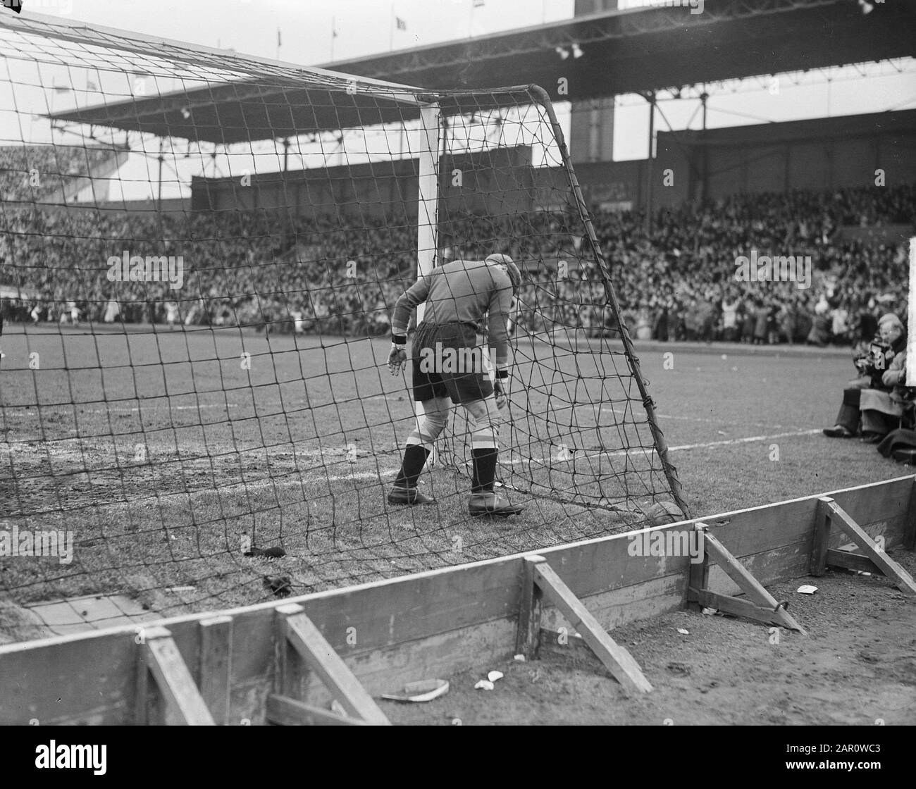 Netherlands-Belgium 3.3. The Belgian deoelman Meert takes ball out of goal after the equalization of Joep Brandes (2-2) Date: 13 March 1949 Location: Amsterdam, Noord-Holland Keywords: sport, football Person name: Brandes Joep, Meert Stock Photo