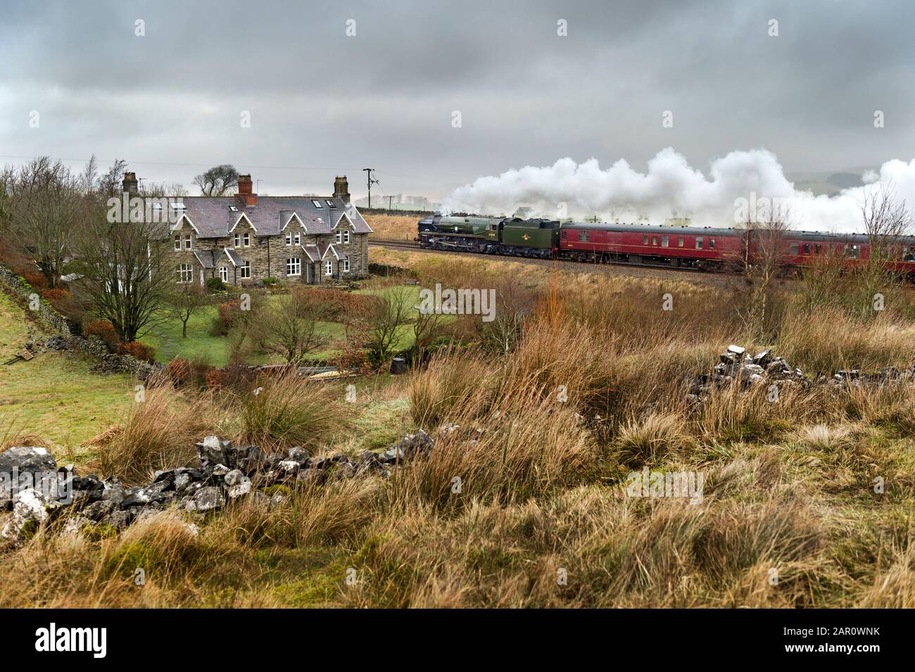 Yorkshire Dales National Park, UK. 25th Jan 2020. On a damp and overcast Winter's day, steam locomotive 'British India Line' hauls The Winter Cumbrian Mountain Express train north to Carlisle up the steep gradient of the Settle-Carlisle railway line at Selside in Ribblesdale. The journey was a round trip from Manchester. Credit: John Bentley/Alamy Live News Stock Photo