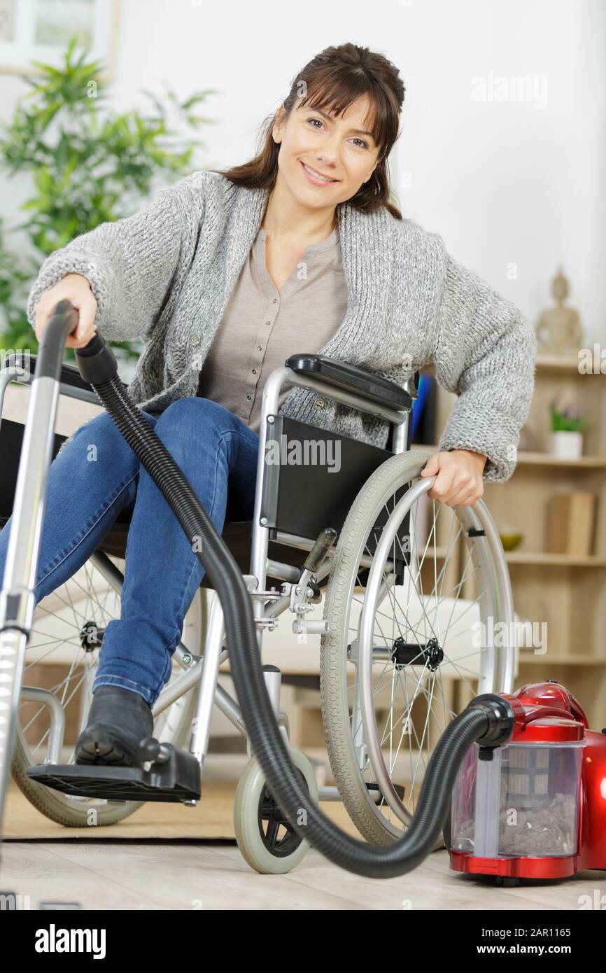 disabled woman using a vacuum cleaner Stock Photo Alamy