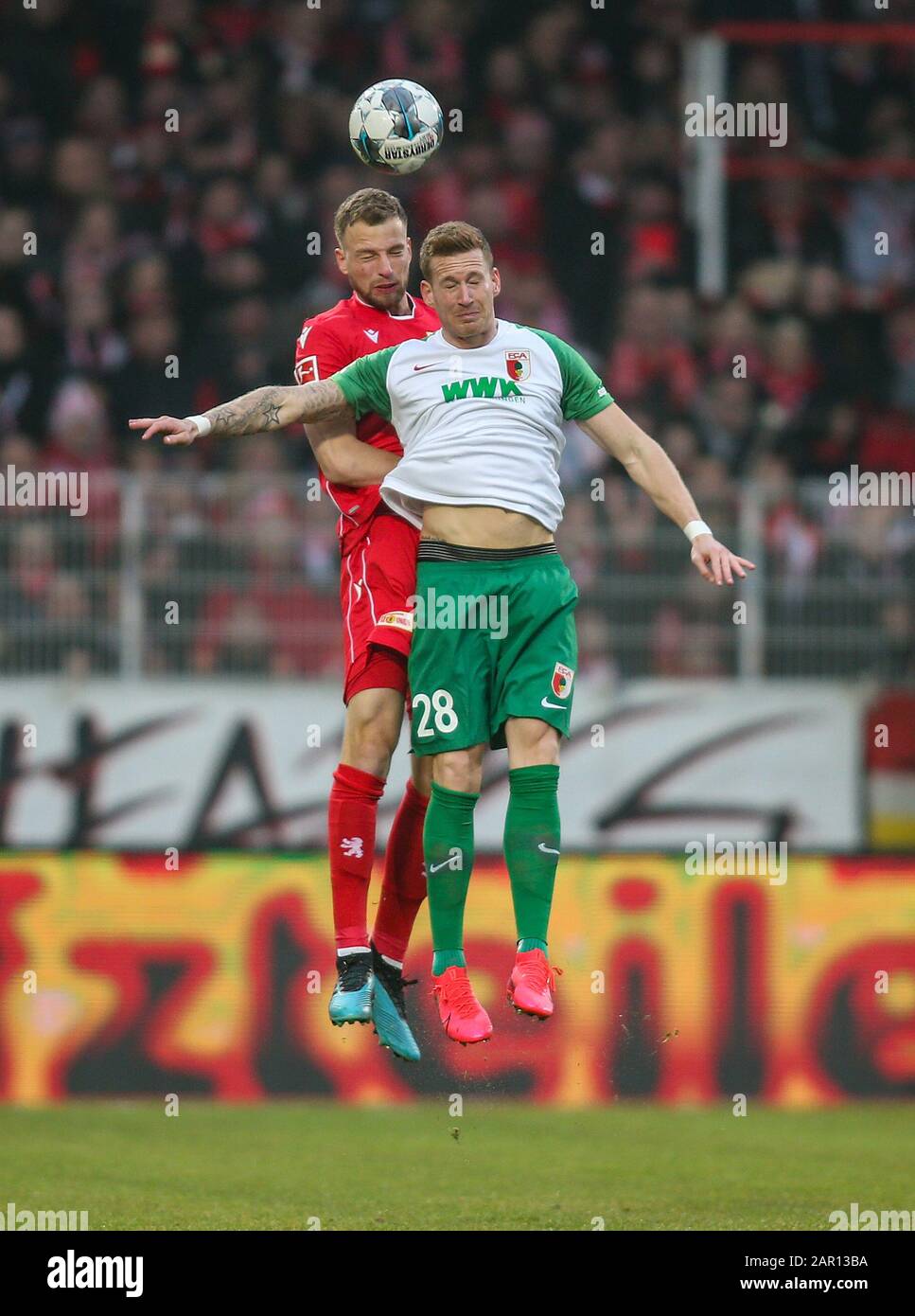 Berlin, Germany. 25th Jan, 2020. Football: Bundesliga, 1st FC Union Berlin - FC Augsburg, 19th matchday, An der Alten Försterei stadium. Berlin's Marvin Friedrich (l) jumps to a header against Andre Hahn of FC Augsburg. Credit: Andreas Gora/dpa - IMPORTANT NOTE: In accordance with the regulations of the DFL Deutsche Fußball Liga and the DFB Deutscher Fußball-Bund, it is prohibited to exploit or have exploited in the stadium and/or from the game taken photographs in the form of sequence images and/or video-like photo series./dpa/Alamy Live News Credit: dpa picture alliance/Alamy Live News Stock Photo