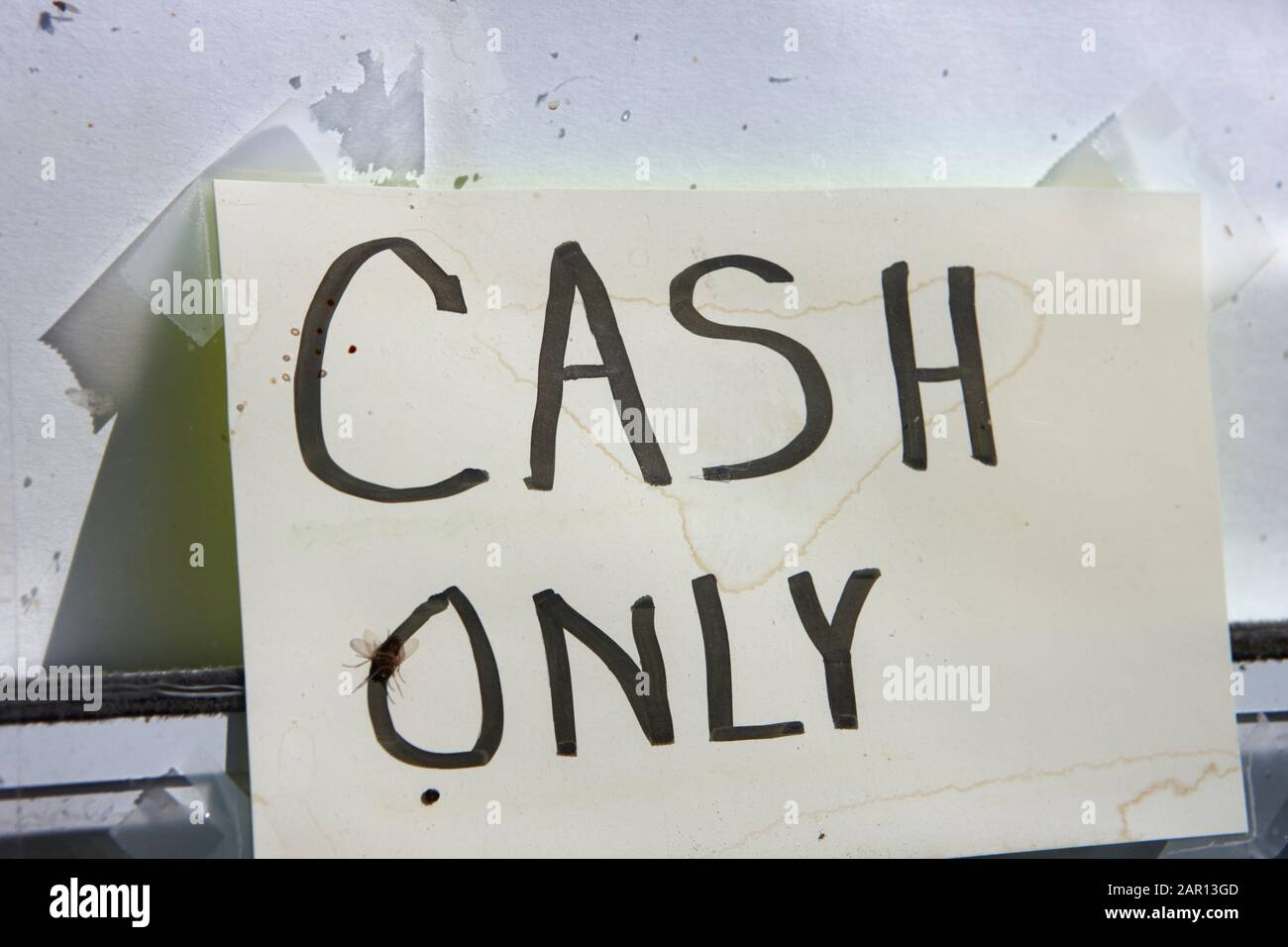 old weathered cash only sign in the window of a rural store Stock Photo